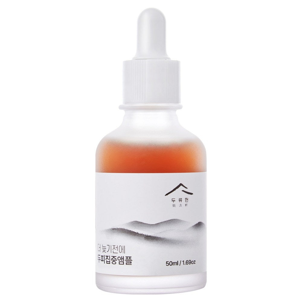 Dooryuheon scalp ampoule single bottle with amber liquid, a white dropper and a grey mountain-style label