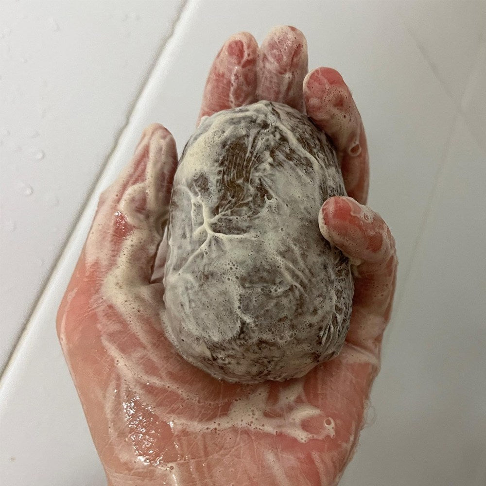 Cheonbinusop Jeongango soap bar covered in pale foam and held upright in a wet palm
