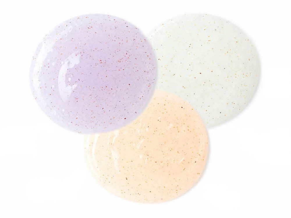 Veilment scrub body wash textures in three overlapping lavender, pale green and peach gel circles with visible grains