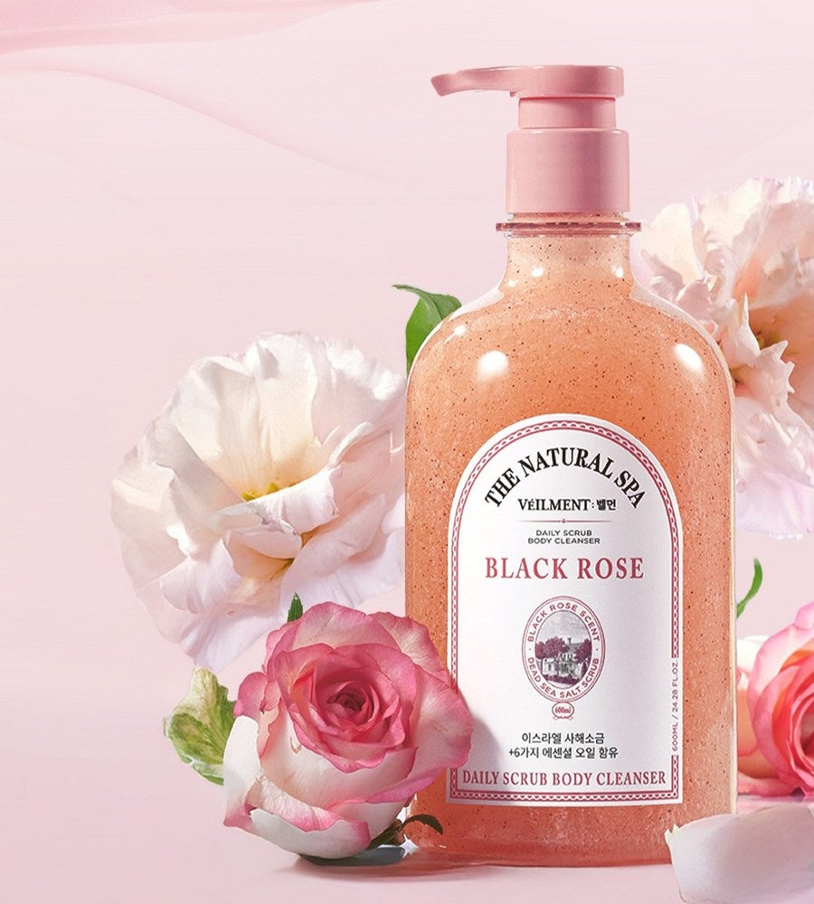 Veilment Black Rose scrub body wash close-up with a pink pump, white label and roses against a pink backdrop