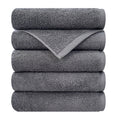 Songwol Crush hotel towels in dark gray, stacked five high with one corner unfolded to show the woven border