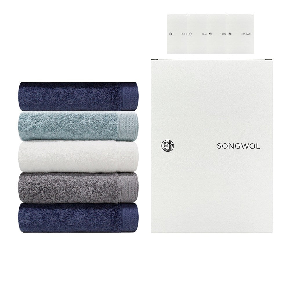 Songwol face towel set with five folded towels in navy, pale blue, white and grey beside white branded cases