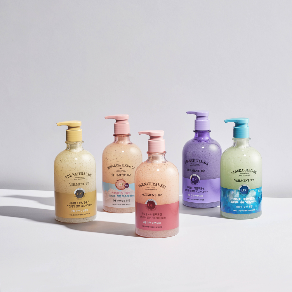 Veilment body wash range with five pastel pump bottles, including a pink Black Rose bottle at the front