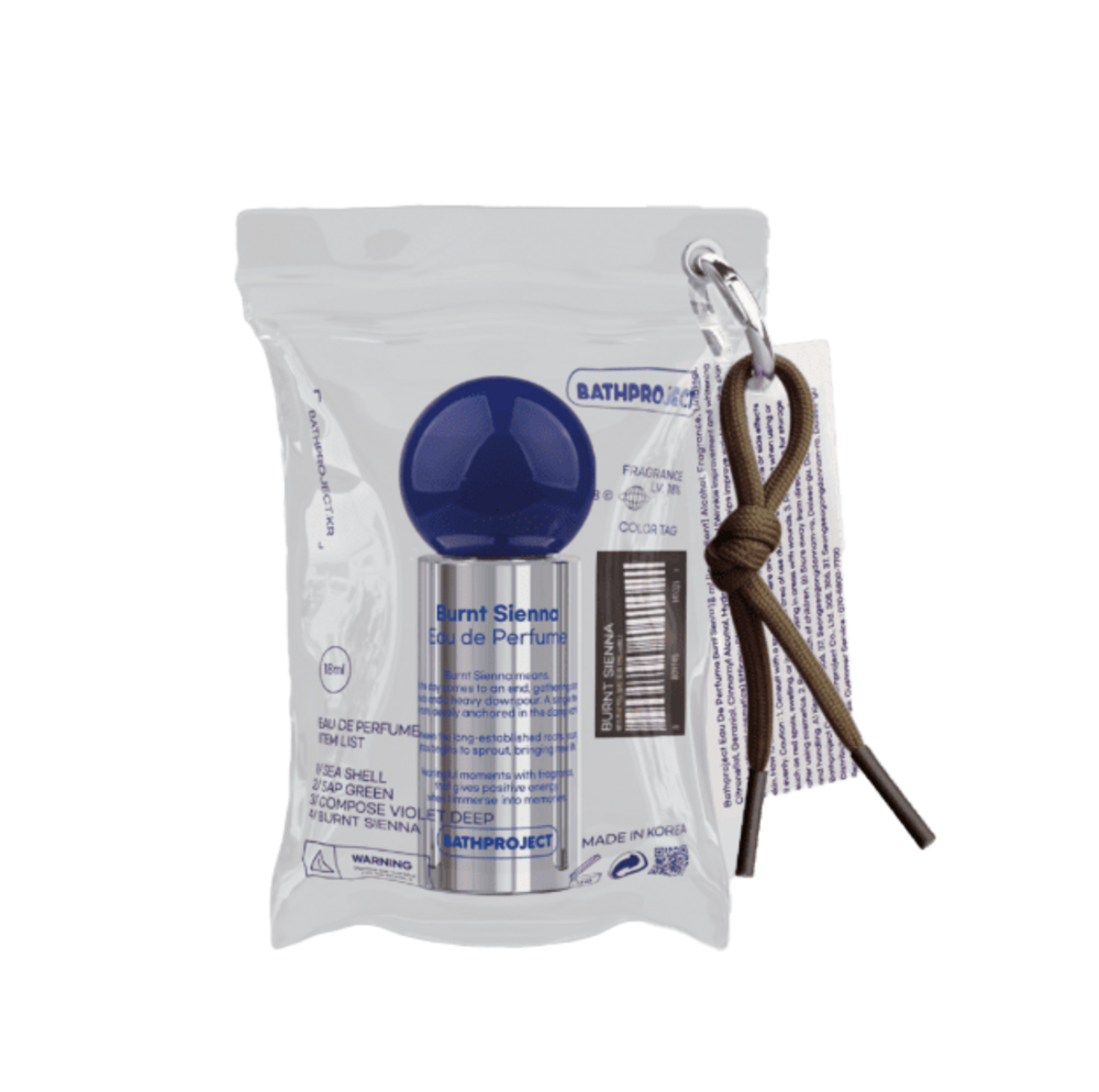 Bath Project eau de parfum silver bottle with a blue round cap inside a clear pouch beside a cord keyring