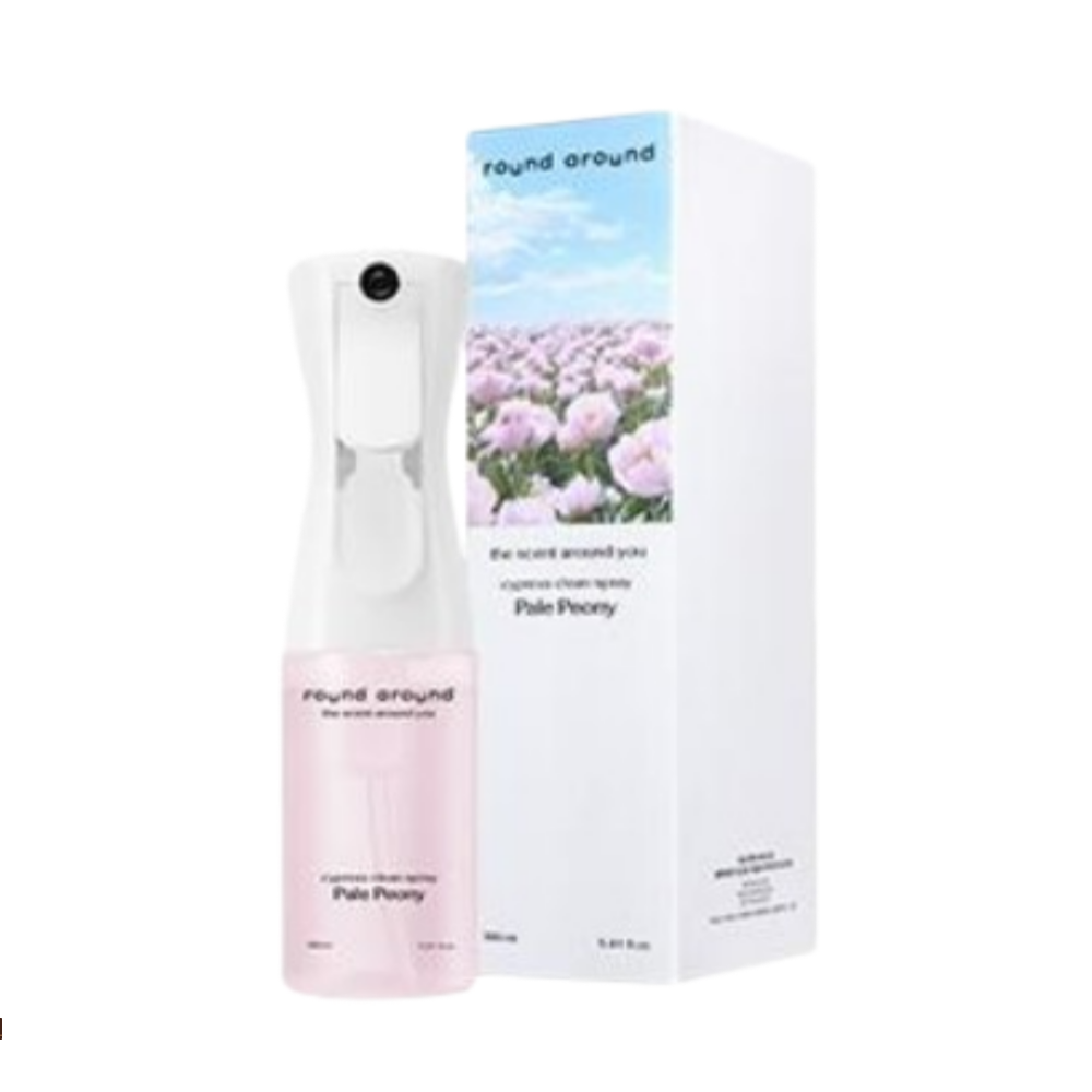 Round Around Hinoki clean spray in a pale pink-labelled bottle beside a white carton with pink peony flowers