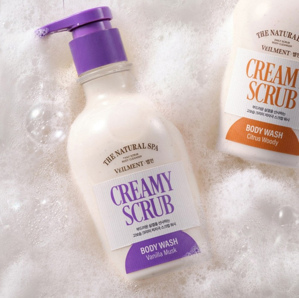 Veilment Vanilla Musk body wash lying in white foam beside a partially visible Citrus Woody bottle