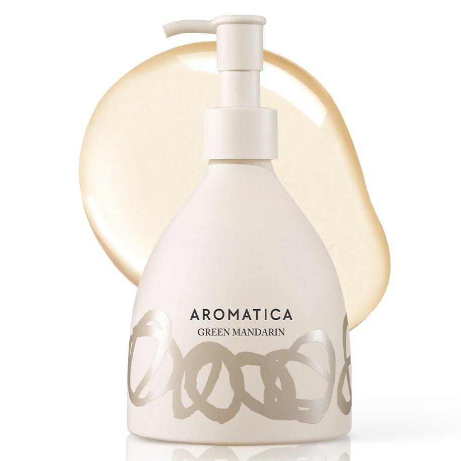 AROMATICA Green Mandarin Hand Soap in a pale patterned pump bottle against a translucent golden cleanser smear.