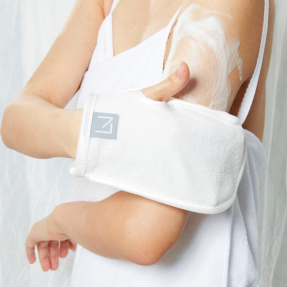 Purelevy Exfoliating Soap Set white glove held against a lathered upper arm, showing its soft-looking texture