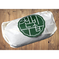 Cheonbinusop Jeongango soap bar wrapped in white paper with a round dark green Korean label on a wooden surface