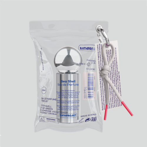 Bath Project portable perfume in Seashell, inside a clear pouch with a silver round cap and grey pink-tipped cord