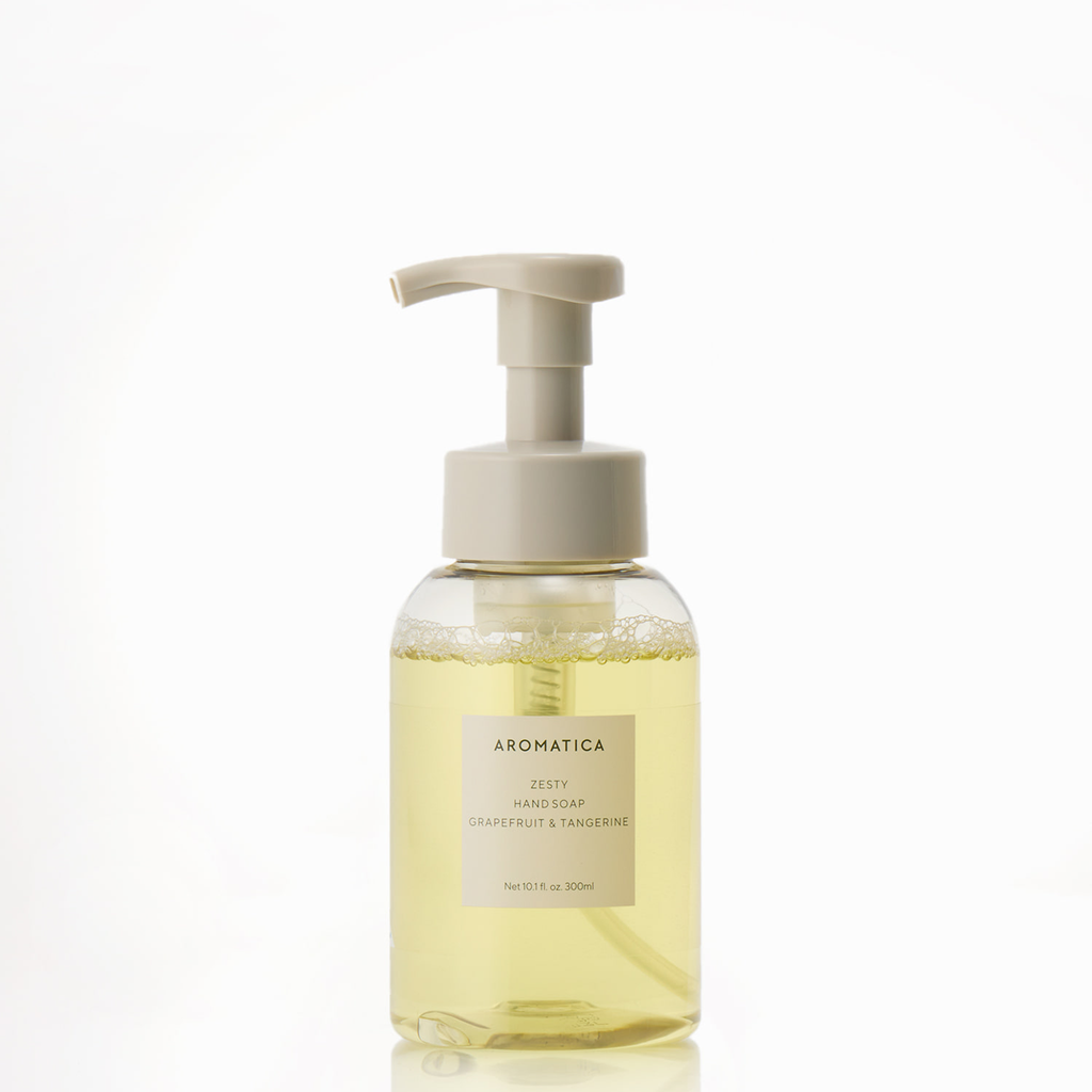 Aromatica Zesty Hand Soap with pale yellow liquid, a cream foaming pump and a grapefruit and tangerine label