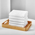 Songwol cotton towels shown as five folded white towels stacked on a wooden tray with cutout handles