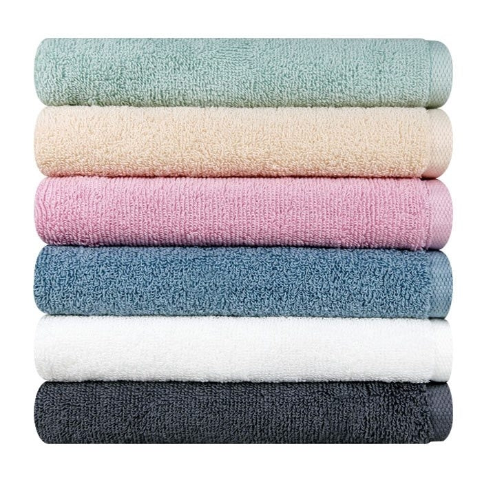 Songwol towel set showing six folded solid-colour towels with textured surfaces against a white background
