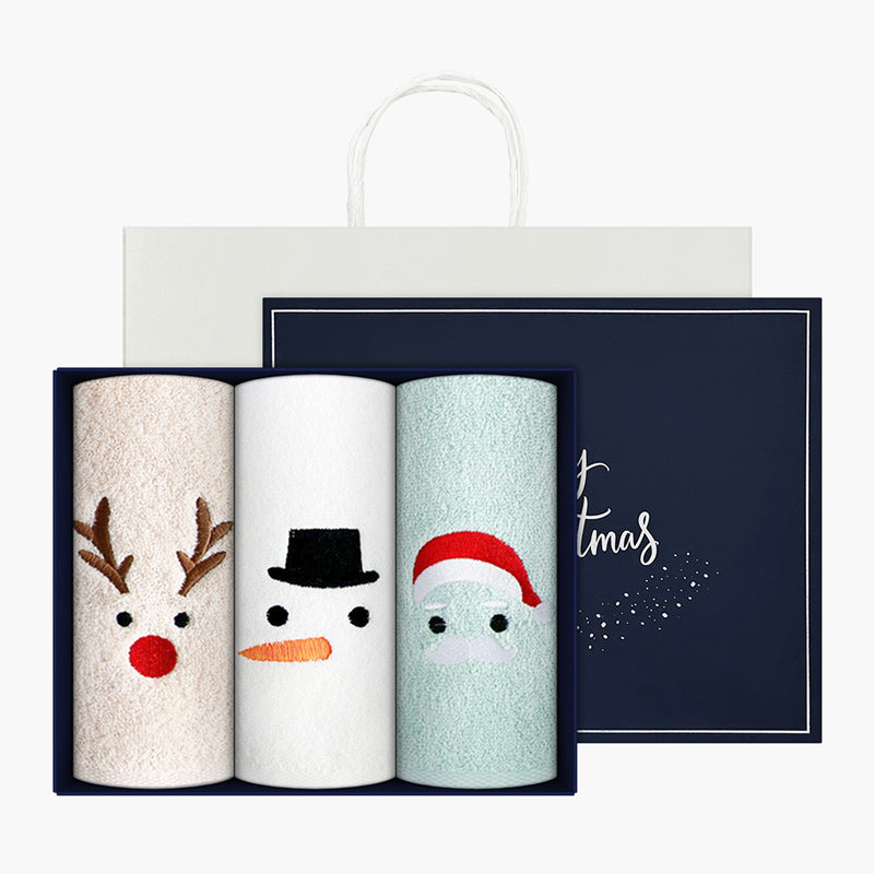 Songwol Christmas towel set showing three rolled character towels, a navy box and a white shopping bag
