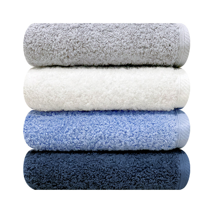 Songwol cotton face towels shown front-on in a four-towel stack, highlighting dense loops and woven borders