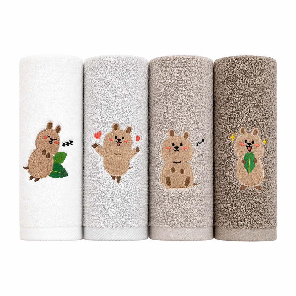 Songwol Quokka face towels in four neutral shades, rolled upright to show different embroidered characters