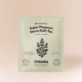 Odada Super Mugwort Sauna Bath Tea in a pale green 50 g pouch with black botanical artwork on a peach background