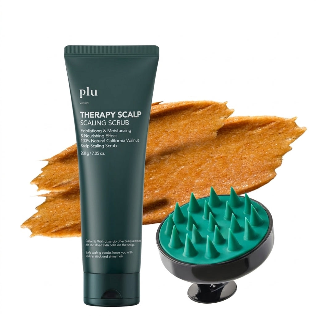 PLU scalp scrub in a dark green tube beside a green-tipped massage brush and an orange-brown textured smear