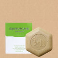 Kim Seok-ho Forest soap bar with a beige flecked surface and embossed centre beside a green-and-white box
