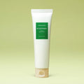 Aromatica Rosemary 3-in-1 Hair Treatment in a tall white tube with a green label and beige cap against a green backdrop