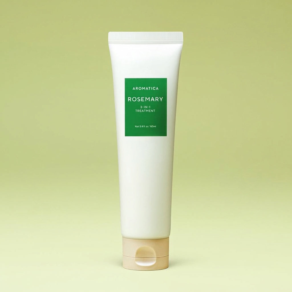 Aromatica Rosemary 3-in-1 Hair Treatment in a tall white tube with a green label and beige cap against a green backdrop