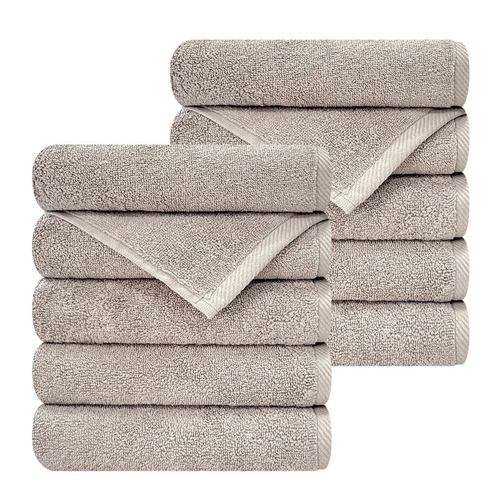 Songwol Crush hotel towels in light gray on white, showing two overlapping stacks and textured woven borders